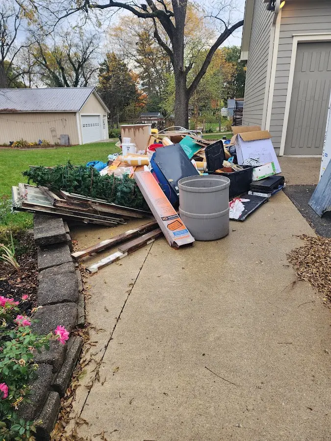 Dumpster being loaded with debris for 12 Yard Dumpster Rental in Richland